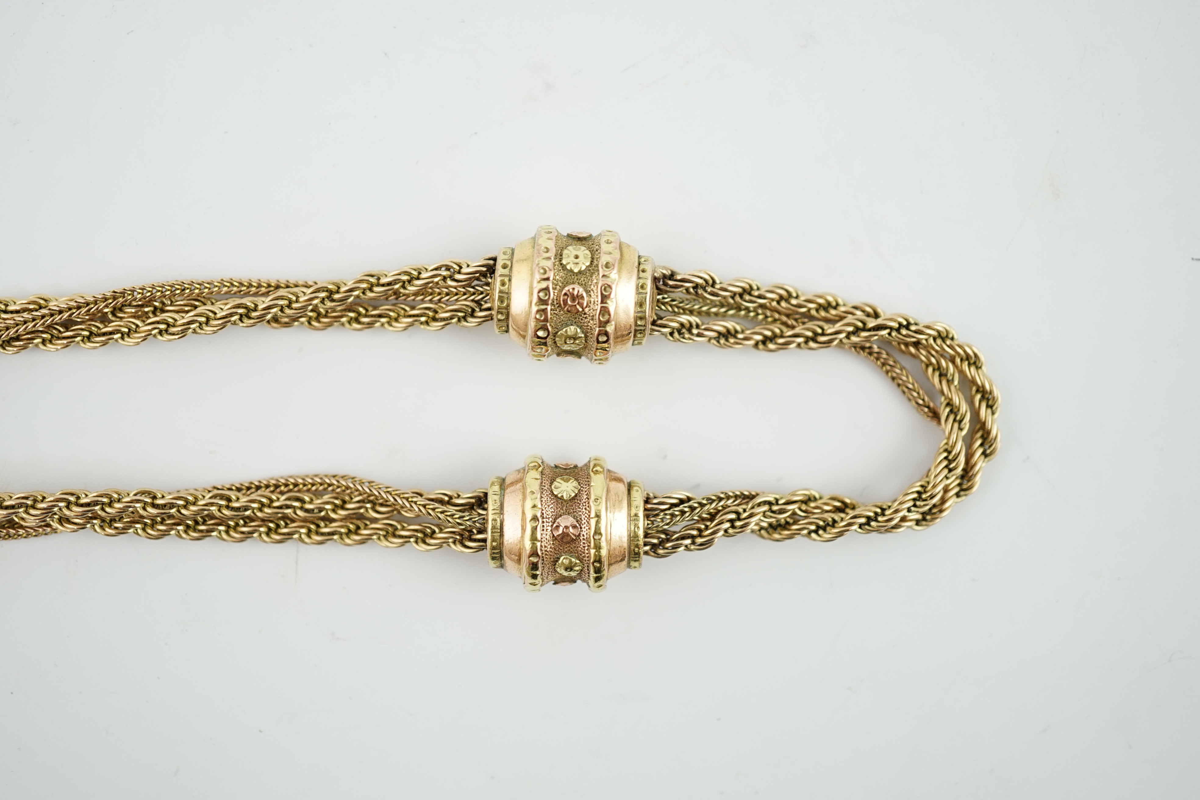 A Victorian two colour gold triple strand Albertina